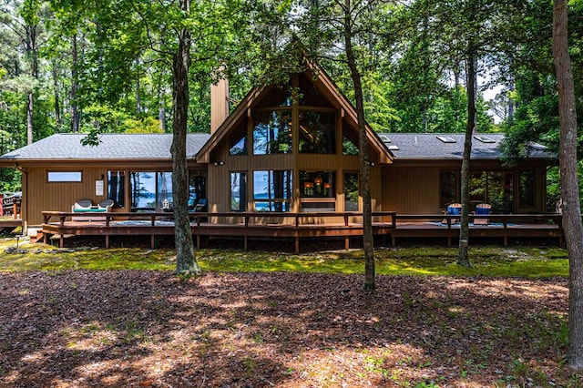 rear view of house featuring a wooden deck