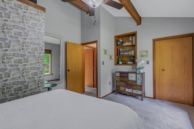 bedroom featuring carpet, ceiling fan, and vaulted ceiling with beams