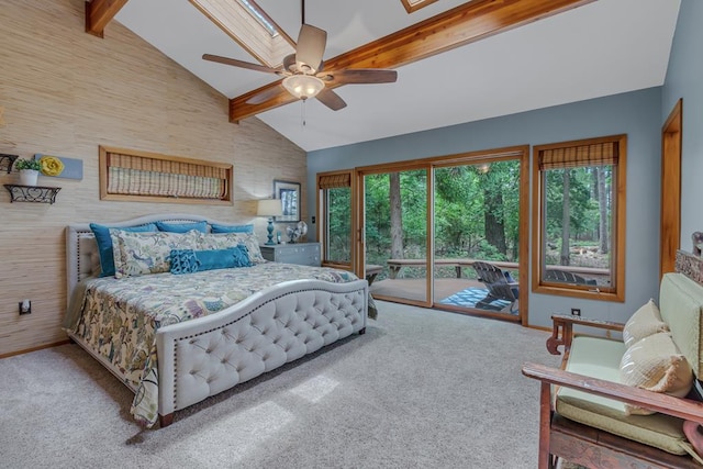 bedroom featuring access to exterior, carpet flooring, a skylight, ceiling fan, and beamed ceiling