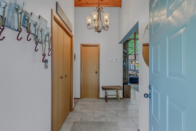 entryway with a high ceiling and a chandelier