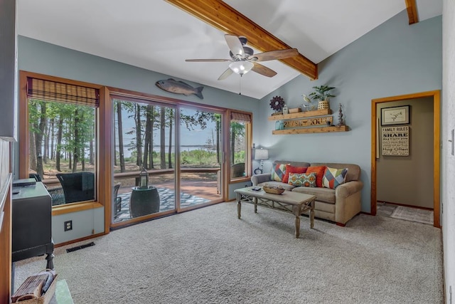 carpeted living room with lofted ceiling with beams and ceiling fan