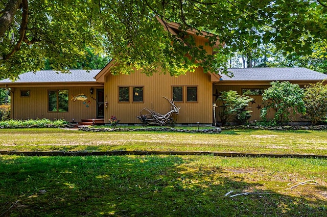 rear view of house with a yard