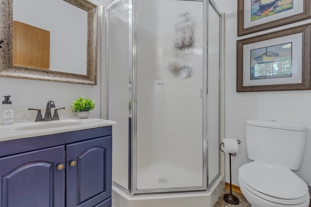 bathroom with vanity, an enclosed shower, and toilet