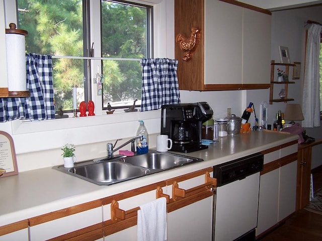 kitchen featuring dishwasher, white cabinets, and sink