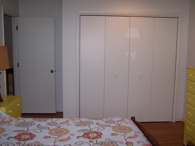 bedroom with dark wood-type flooring