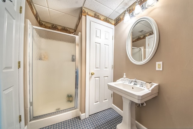 403 Moores Creek Dr, Deltaville, VA 23043 - bathroom with a paneled ceiling, a stall shower, and baseboards