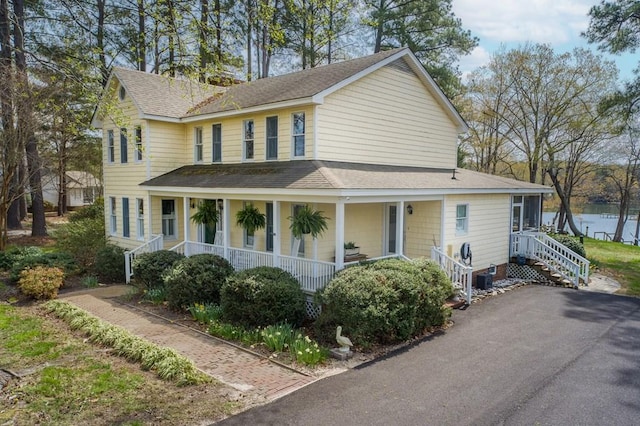 403 Moores Creek Dr, Deltaville, VA 23043 - view of front facade with roof with shingles, covered porch, and a water view