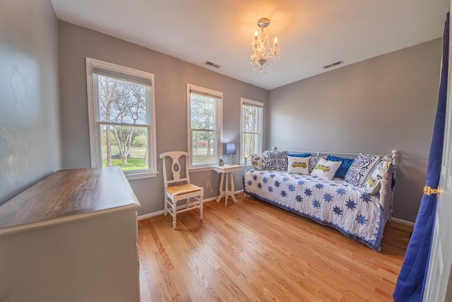 403 Moores Creek Dr, Deltaville, VA 23043 - bedroom featuring wood finished floors, a chandelier, and baseboards