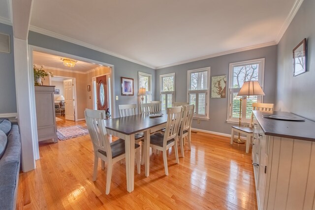 403 Moores Creek Dr, Deltaville, VA 23043 - dining area with light wood finished floors, baseboards, and ornamental molding