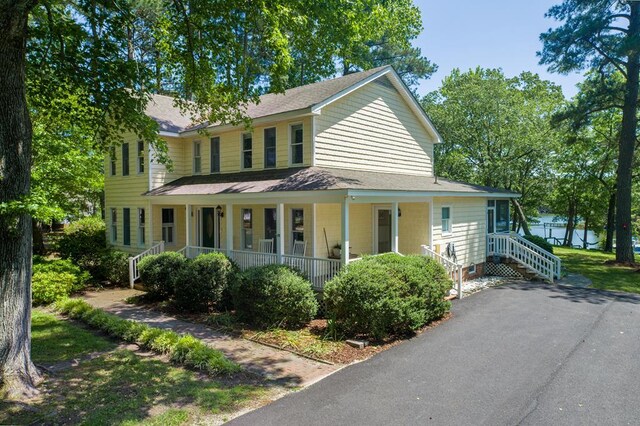 403 Moores Creek Dr, Deltaville, VA 23043 - view of front of house featuring covered porch and a shingled roof