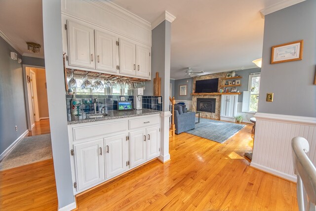 403 Moores Creek Dr, Deltaville, VA 23043 - indoor bar with ornamental molding, light wood-style floors, a fireplace, ceiling fan, and decorative backsplash
