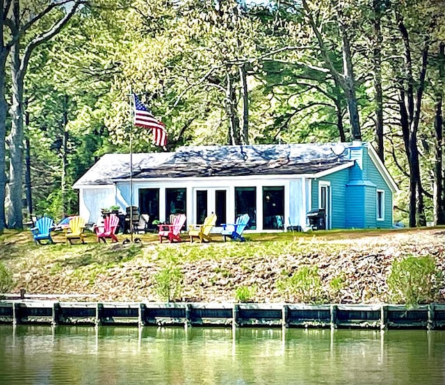 rear view of property featuring a water view