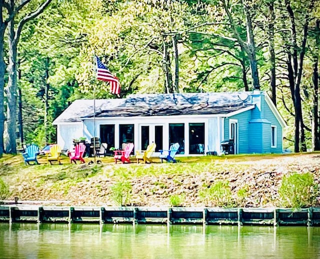 rear view of property with a water view