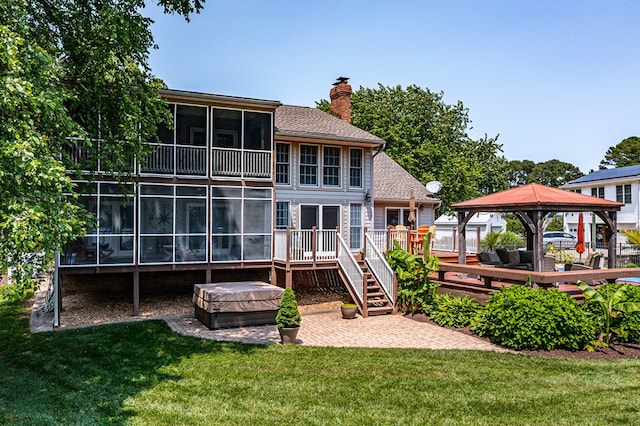 324 Bayberry Ln, Reedville, VA 22539 - back of property with a gazebo, a deck, a covered hot tub, and a lawn