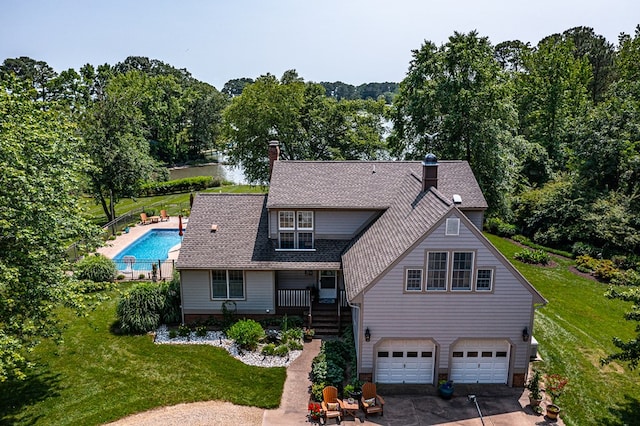 324 Bayberry Ln, Reedville, VA 22539 - view of front of house with a garage, driveway, and a chimney