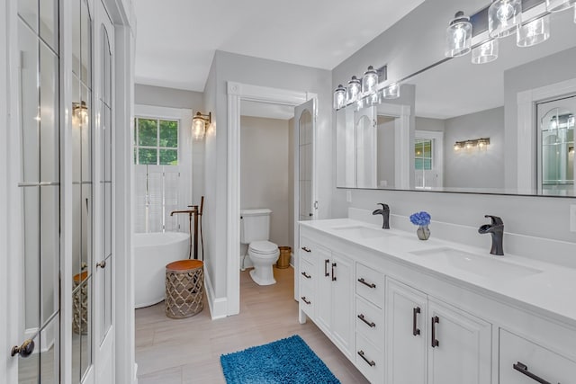 324 Bayberry Ln, Reedville, VA 22539 - full bathroom featuring double vanity, a freestanding tub, and toilet
