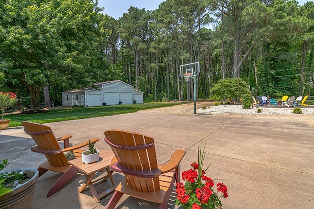 324 Bayberry Ln, Reedville, VA 22539 - view of patio / terrace featuring an outdoor fire pit, a detached garage, and an outbuilding