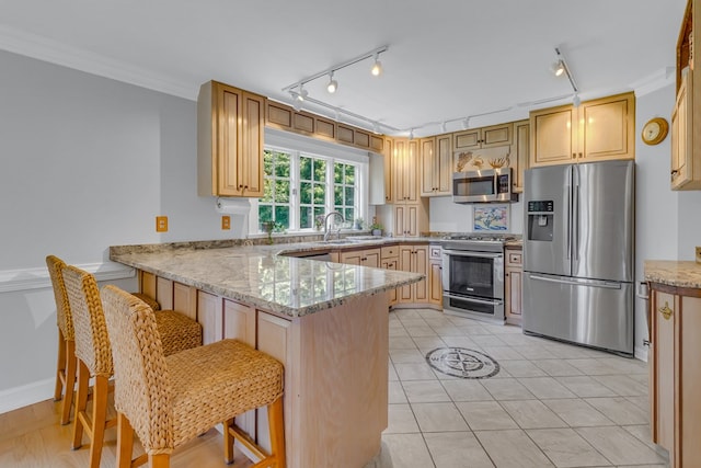 324 Bayberry Ln, Reedville, VA 22539 - kitchen with appliances with stainless steel finishes, a peninsula, light stone counters, a sink, and a breakfast bar