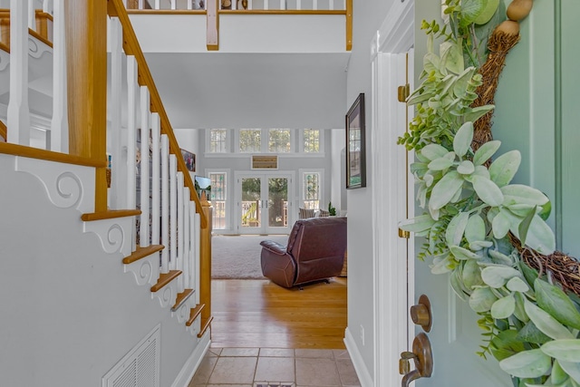 324 Bayberry Ln, Reedville, VA 22539 - entrance foyer with stairs, a towering ceiling, light tile patterned flooring, french doors, and baseboards