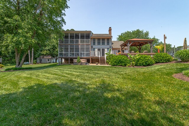 324 Bayberry Ln, Reedville, VA 22539 - rear view of house featuring a sunroom, a chimney, a gazebo, and a yard