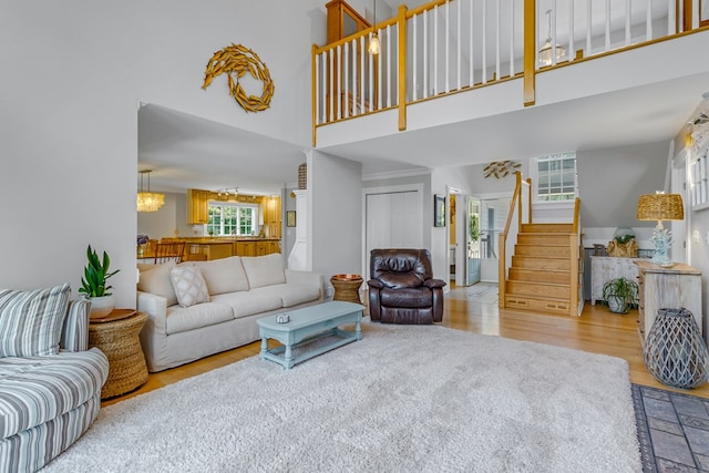 324 Bayberry Ln, Reedville, VA 22539 - living area with a high ceiling, wood finished floors, stairway, and a chandelier