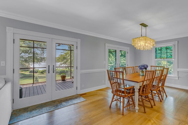 324 Bayberry Ln, Reedville, VA 22539 - dining room featuring french doors, a chandelier, ornamental molding, light wood-style flooring, and baseboards
