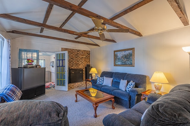 carpeted living room featuring lofted ceiling with beams, a brick fireplace, and ceiling fan