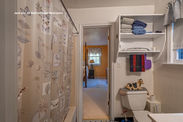 bathroom featuring shower / tub combo and toilet