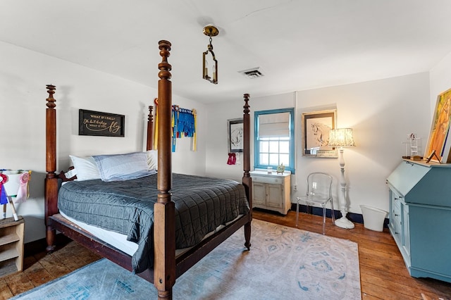 bedroom featuring hardwood / wood-style floors and visible vents