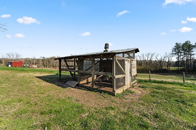 view of poultry coop featuring a lawn