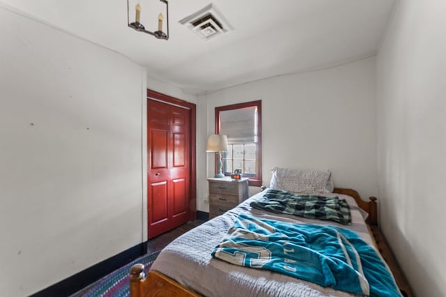 bedroom featuring baseboards and visible vents