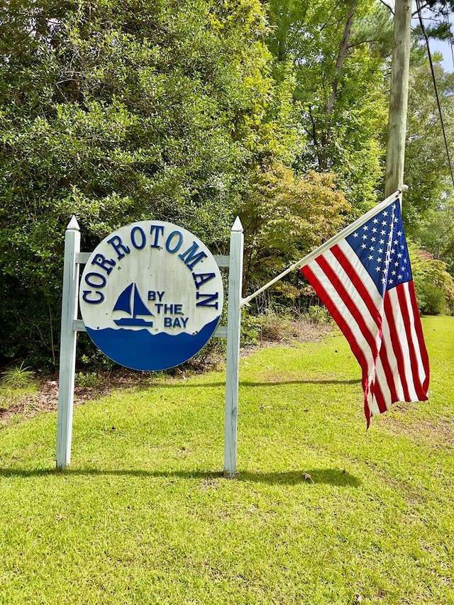 community / neighborhood sign with a yard