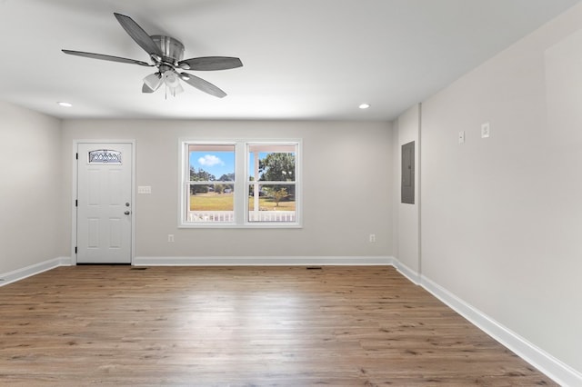 foyer featuring electric panel, light hardwood / wood-style flooring, and ceiling fan