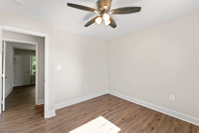 empty room with hardwood / wood-style flooring and ceiling fan