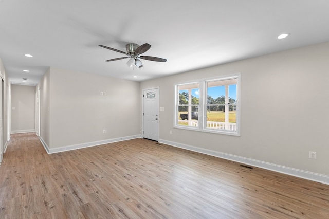 unfurnished room with ceiling fan and light wood-type flooring