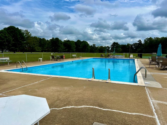 view of swimming pool with a patio area