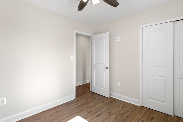 unfurnished bedroom with a closet, ceiling fan, and hardwood / wood-style flooring