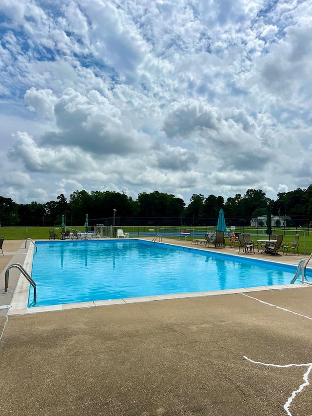 view of swimming pool featuring a patio area