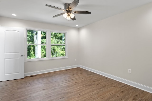 spare room with ceiling fan and light wood-type flooring