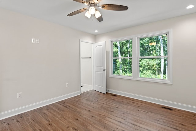 empty room featuring ceiling fan and wood-type flooring