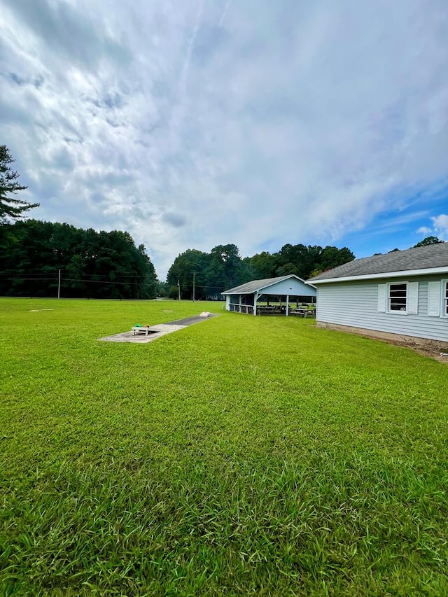 view of yard featuring a fire pit and a carport