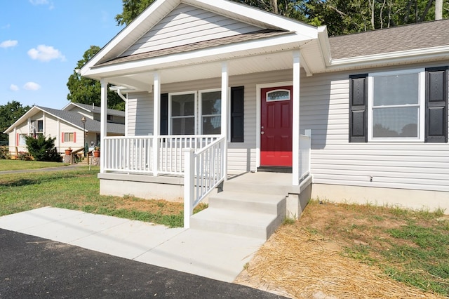 view of front of property with a porch and a front yard