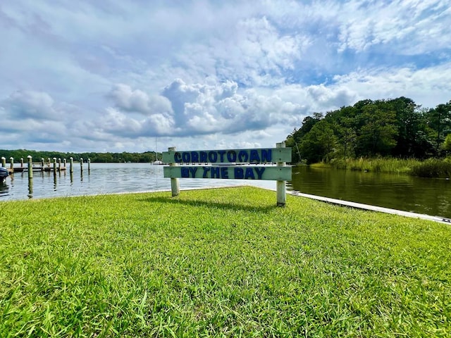 view of dock featuring a yard and a water view