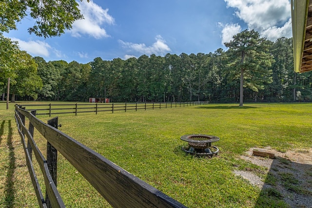 view of yard featuring a fire pit and a rural view