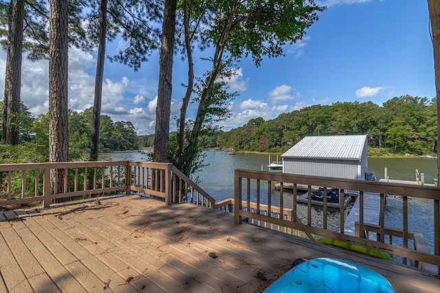 wooden terrace featuring a boat dock and a water view