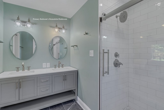 bathroom featuring tile patterned flooring, vanity, and a shower with shower door