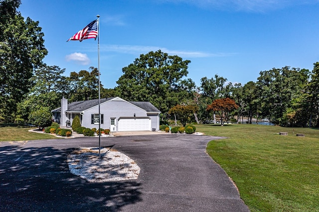 view of front facade with a front yard and a garage