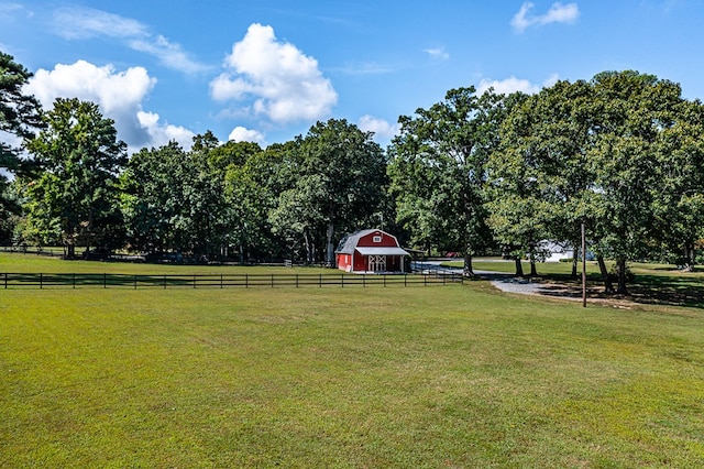 view of yard with a rural view and an outdoor structure