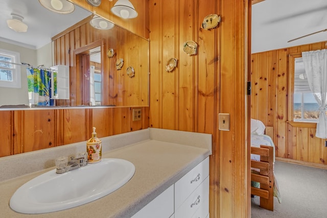 bathroom featuring vanity and wood walls