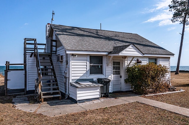 view of front of house with a water view